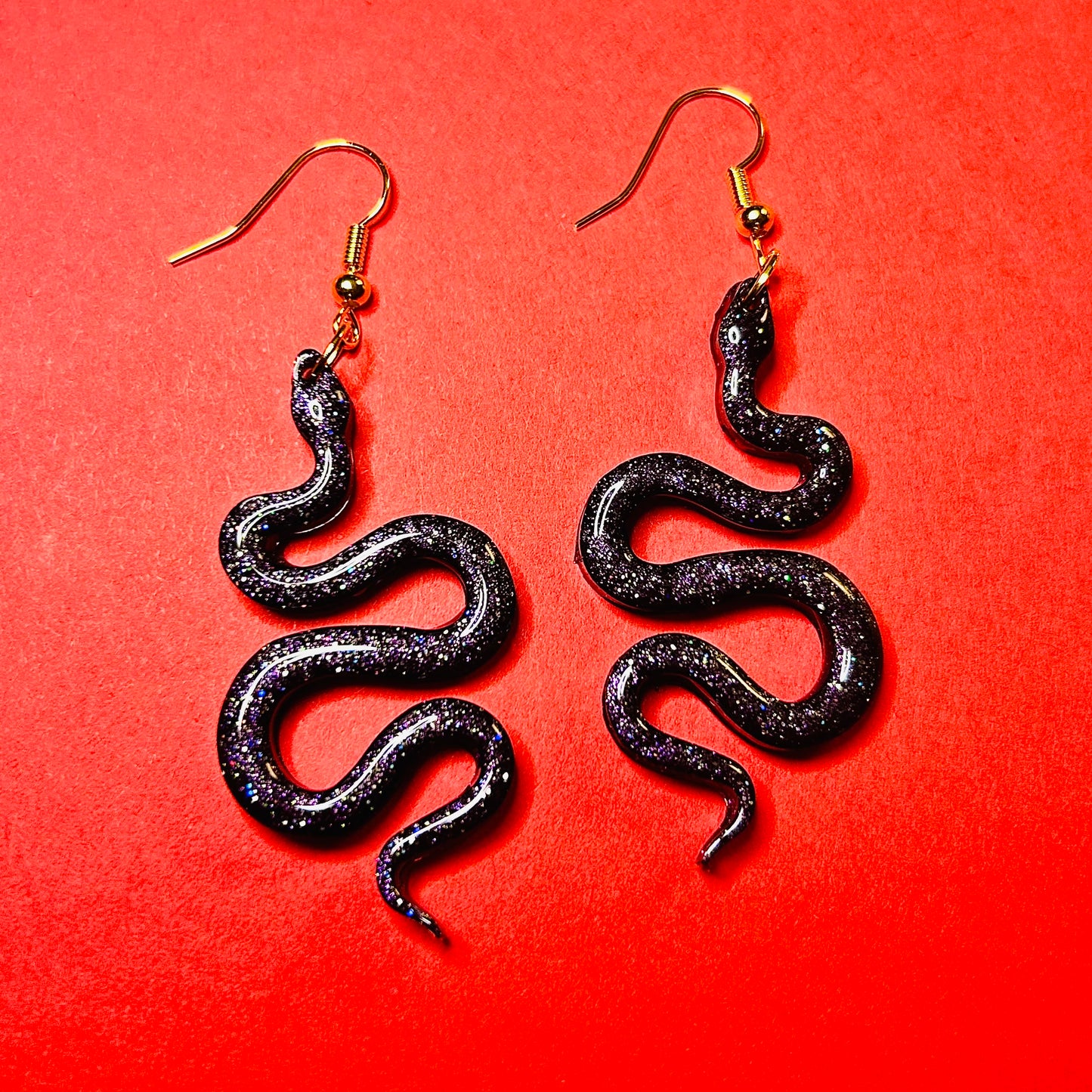 "Midnight Serpents" Black multicolored glitter snake resin earrings